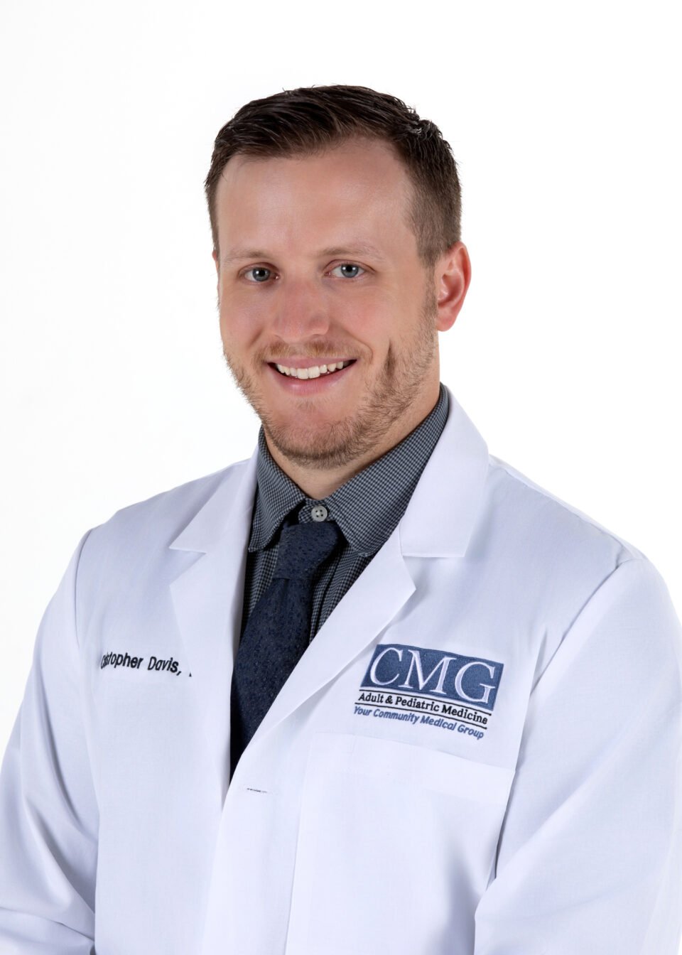 Christopher Davis, D.O., Wearing a White Medical Coat and Tie in Clarkston, MI